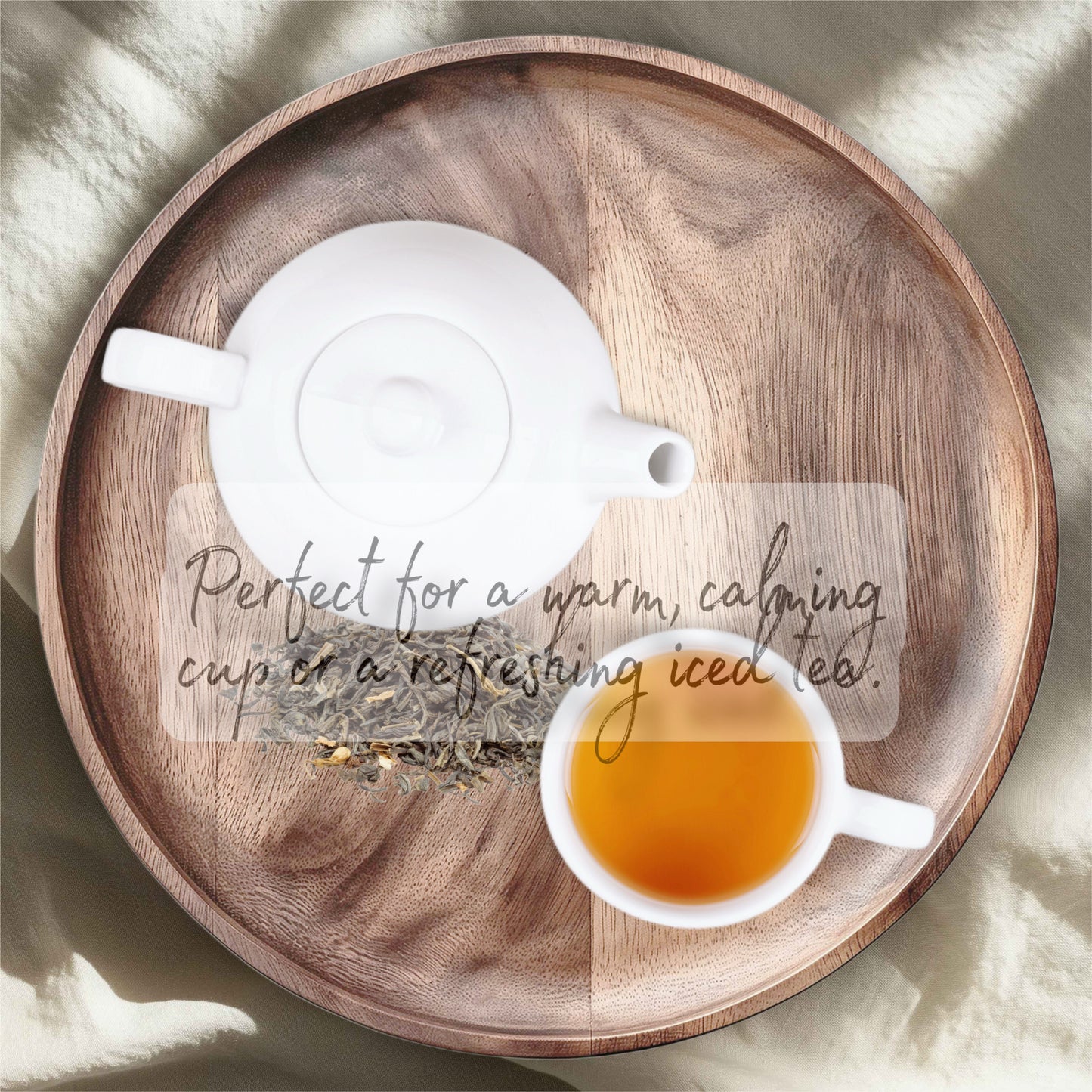 Tea set with a teapot, tea bag, and cup of tea on a wooden tray.