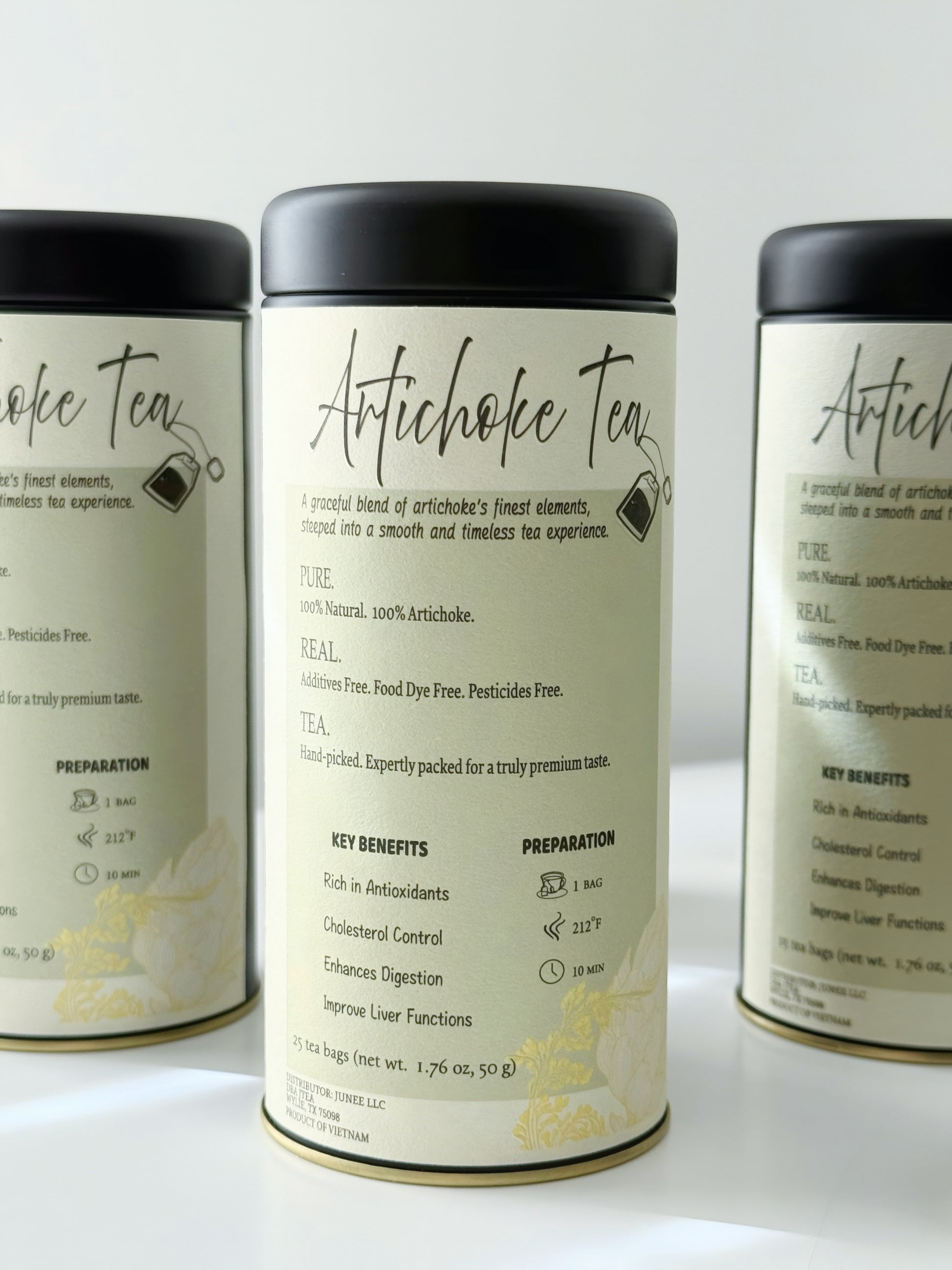 Three cans of Artichoke Tea on a white background