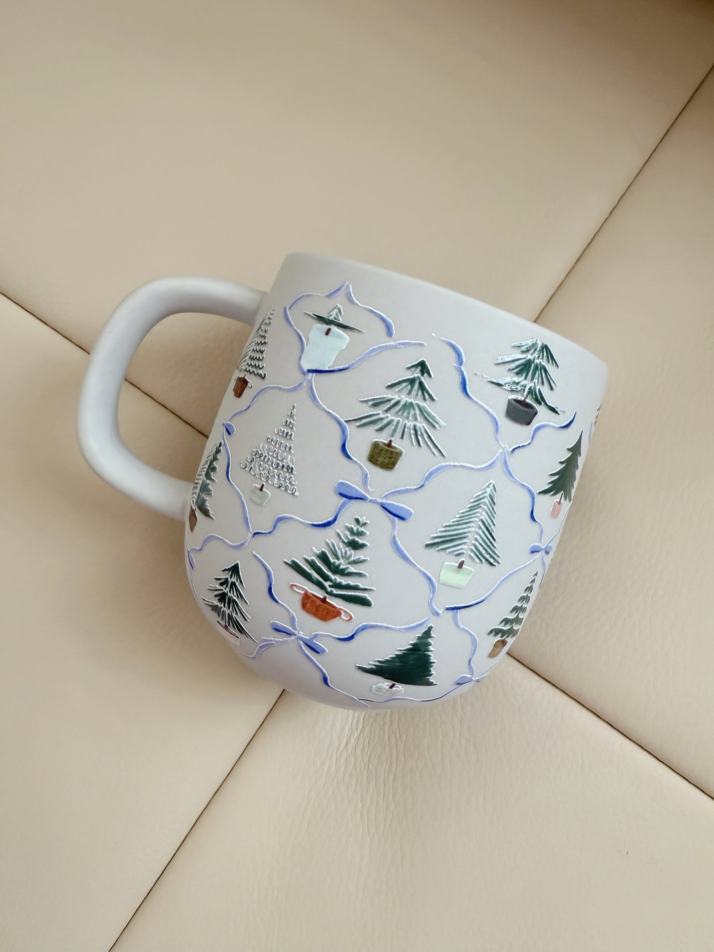 Mug with a winter scene design on a beige surface