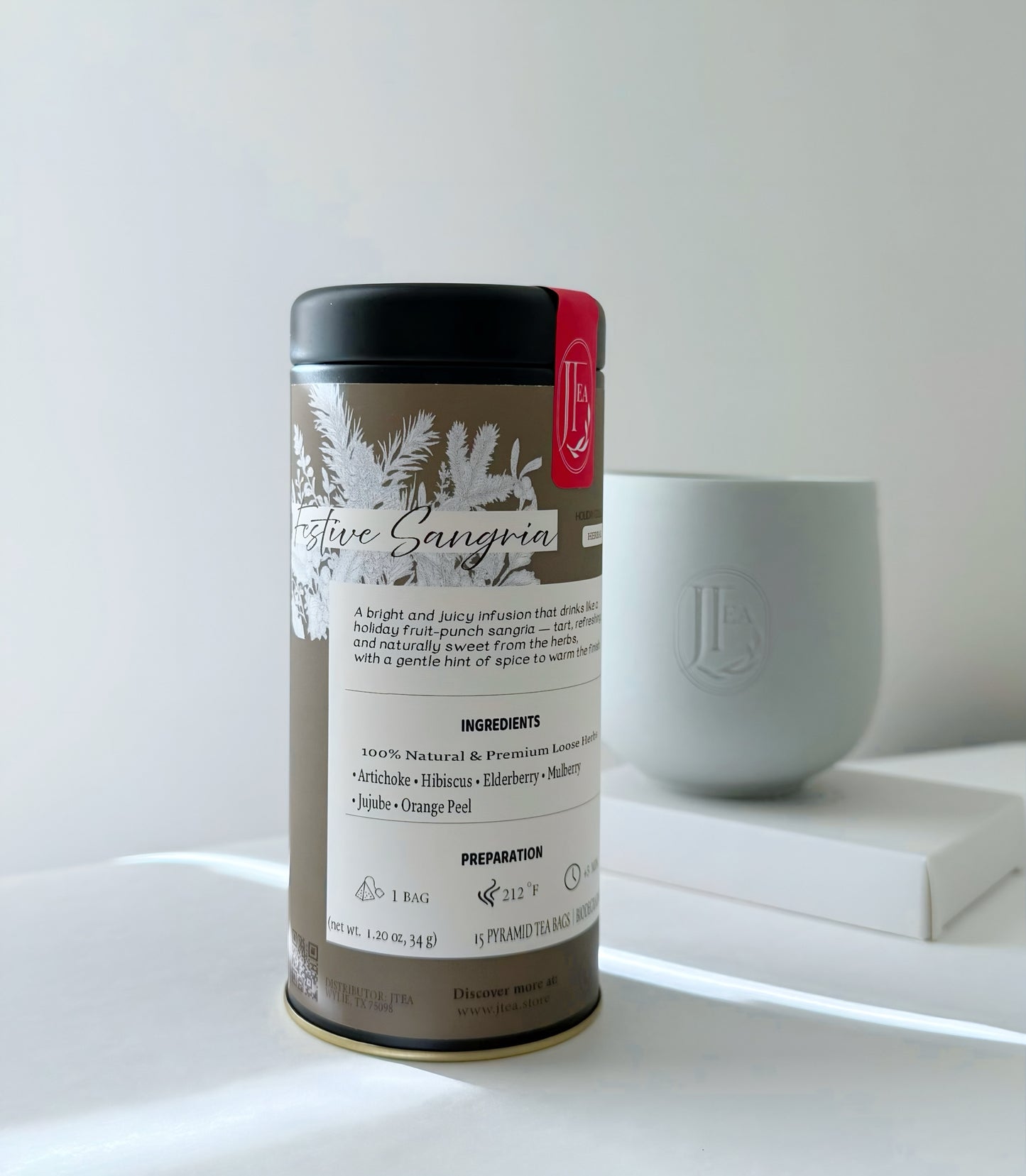 Tea canister labeled 'Nature Sangria' on a white surface with a blurred background