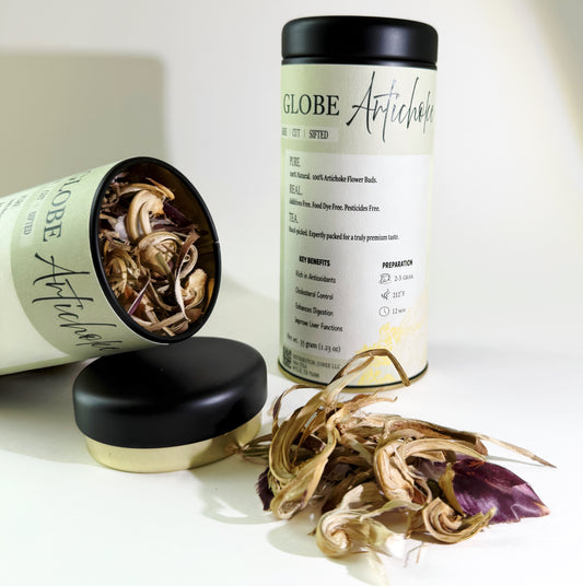 Two cans of 'Globe Artichoke' with their lids off, revealing dried artichoke flowers on a white background.